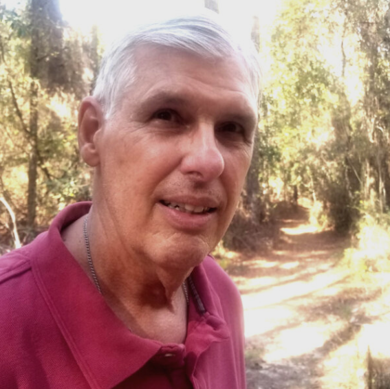 Bob Bob smiling in front of a forest trail