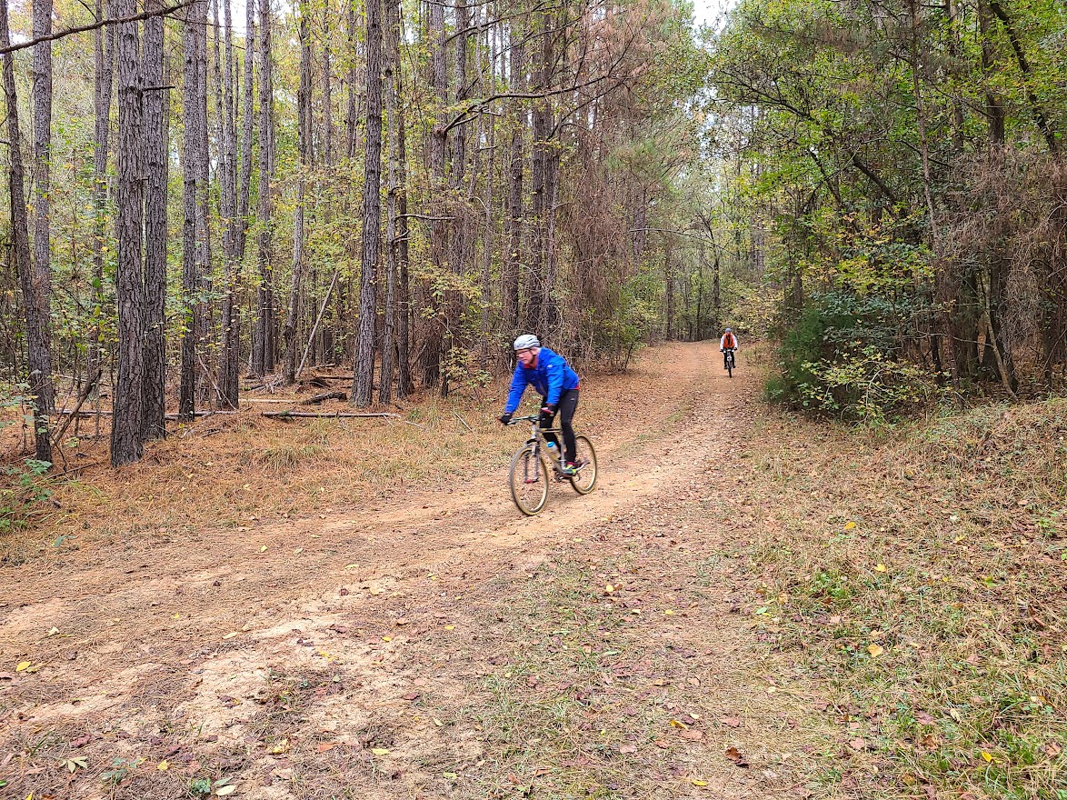 ClemsonLloyd3 2 bikers in the distance riding trail at Clemson Lloyd Property