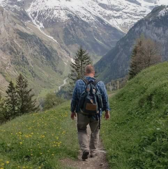Tom Sliker hiking in the mountains